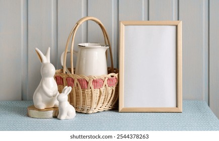 A charming spring display with white ceramic rabbits beside a wicker basket and a classic pitcher, set against a light blue textured surface, inviting a festive atmosphere. - Powered by Shutterstock