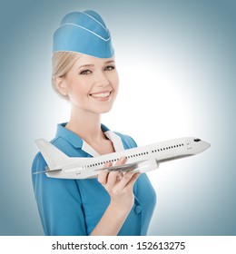 Charming Stewardess Holding Airplane In Hand.