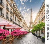 A charming street in Paris with cafes, flowers, and the Eiffel Tower in the background