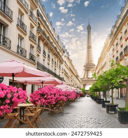 A charming street in Paris with cafes, flowers, and the Eiffel Tower in the background - Powered by Shutterstock