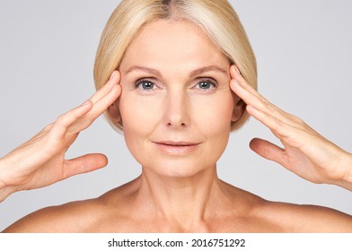 Charming Sweetheart Elderly Woman Dealing With Cleansing The Silky Skin Of Her Face.