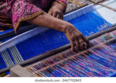 Charming Threads ,Tradition Embracing the timeless art of weaving, this image showcases the grace and skill of a woman as she weaves on a loom.  - Powered by Shutterstock