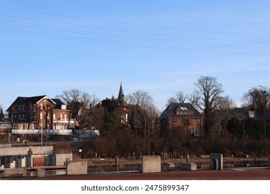 Charming town with historic buildings and clear skies. Explore quaint streets and river views - Powered by Shutterstock