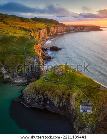 A charming view of the Carrick-a-Rede Rope Bridge at sunrise, Northern Ireland