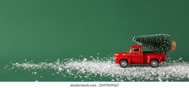 A charming vintage red toy truck carries a miniature Christmas tree across a snowy path. The green background enhances the festive and nostalgic feel of this holiday-themed image - Powered by Shutterstock