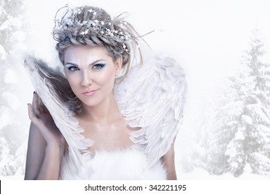 Charming winter queen, posing over winter background 