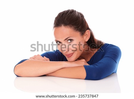 Charming woman looking at you with arms crossed and smiling in white background