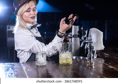 Charming Woman Mixologist Mixes A Cocktail At The Bar Counter