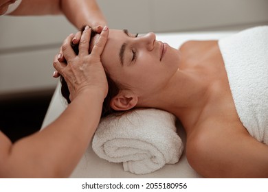 Charming Woman Receiving Professional Scalp Massage In Spa Salon