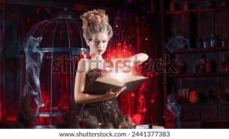 Charming woman witch flowers in hair vintage black dress with book of spell in the old castle. Halloween. Celebration. Witchcraft concept, fairy tale mystic atmosphere. Conjure magic spells