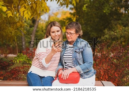 Similar – Woman taking selfie with older mother in wheelchair