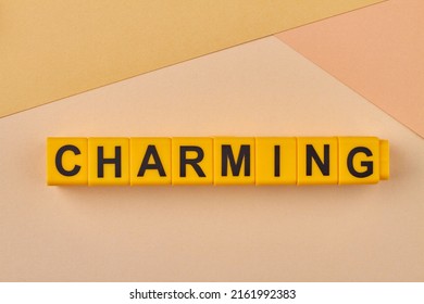 Charming Word Written On Alphabet Blocks On Light Background Close Up. Personality Characteristic.