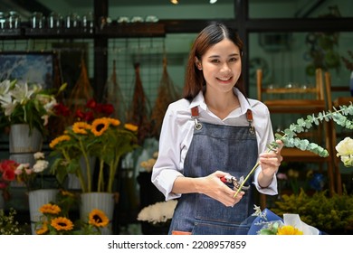 Charming Young Asian Female Florist Or Flower Shop Owner In Apron Making A Beautiful Bouquet, Preparing Flowers For Delivery Order.