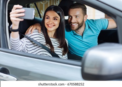 Charming young couple taking pictures of themselves - Powered by Shutterstock