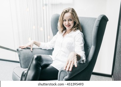 Charming Young Woman In The Chair