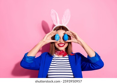 Charming young woman in a festive outfit with bunny ears and Easter eggs against a vibrant pink background - Powered by Shutterstock - Get 15% off with code: PIKWIZARD15