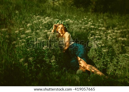 Similar – beautiful young woman siiting outdoors in forest, dreaming with closed eyes in serene pose