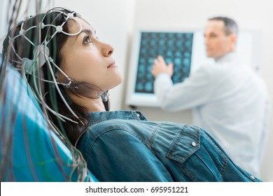 Charming young woman undergoing electroencephalography - Shutterstock ID 695951221