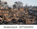 The charred remains of homes stand in the aftermath of the Palisades Fire, showing the devastating effects of the wildfire.