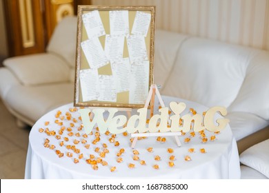 Chart Of The Seating Area Of Guests At The Tables At Restaurant. Easel With Desk On Table And Crystals On Tablecloth.