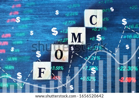 Chart and volume overlay with cube box which have text FOMC, Economic data concept. 