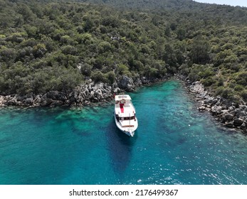 Charter Boat Staying Next To Rocks On The Sea Parking