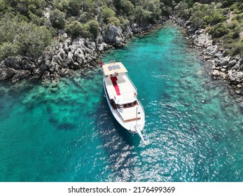 Charter Boat Staying Next To Rocks On The Sea Parking