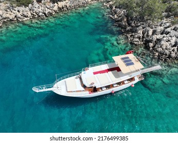 Charter Boat Staying Next To Rocks On The Sea Parking