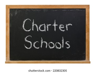 Charter Schools Written In White Chalk On A Black Chalkboard Isolated On White