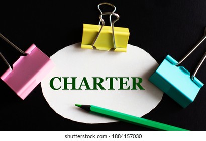 CHARTER - Word On White Paper With Multicolored Clips And Green Pencil. Business Concept