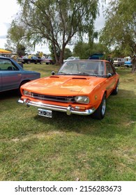 CHASCOMUS, ARGENTINA - Apr 10, 2022: Old IKA Renault Torino Lutteral Comahue Coupe 1968 - 1978 Countryside  Classic Orange Sport Compact Car  Front View  Nature, Grass, Trees  Copyspace