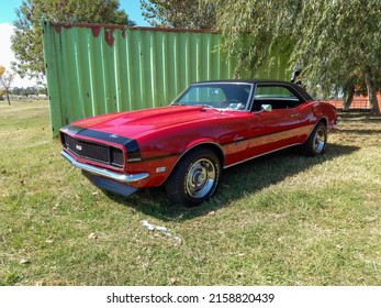 CHASCOMUS, ARGENTINA - Apr 10, 2022: Old Red Sport Chevrolet Camaro SS 396 Coupe First Generation Late 1960s By GM Parked On The Grass  Classic Muscle Car 