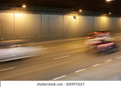 Chase In A Tunnel. Blurred Photo Of Fast Cars Moving At High Speed.