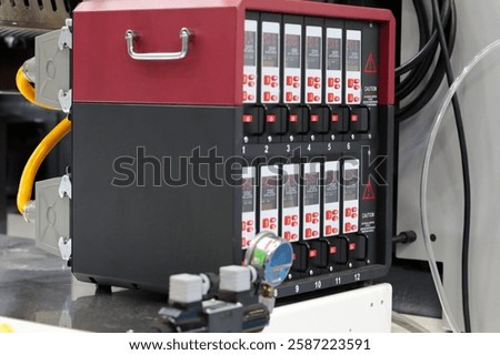 Chassis with digital modular temperature control units for plastic injection molding machine. Multi cavity hot runner temperature controller. Selective focus.