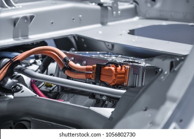 Chassis of the electric car with powertrain and power connections closeup. Blue toned.