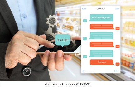 Chat Bot And Future Marketing Concept , Chatbot Icon , Hand Holding Mobile Phone And Gear Popup Out Mobile Screen With Automatic Message Screen With Supermarket Retail Background