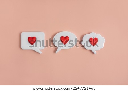Chat icons with hearts on a light background. The concept of modern dating. Receiving or sending love letters. Dating in the social network. Modern love. Copy space.