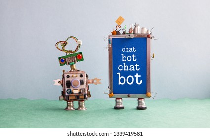 Chatbot artificial intelligence poster. Creative design robot and smartphone gadget with message Chat Bot on blue screen. Modern electronic marketing communication concept. Gray wall green floor 