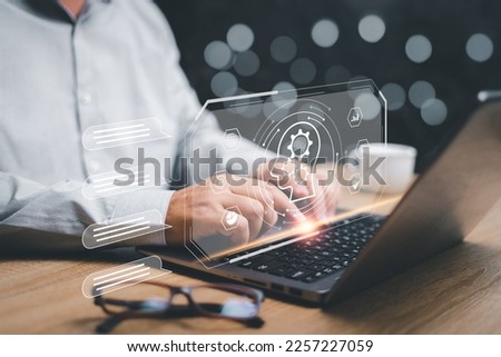 Chatbot and Chat with AI or Artificial Intelligence concept, Businessman use laptops to chat with a smart AI chatbot Artificial Intelligence, Futuristic technology 