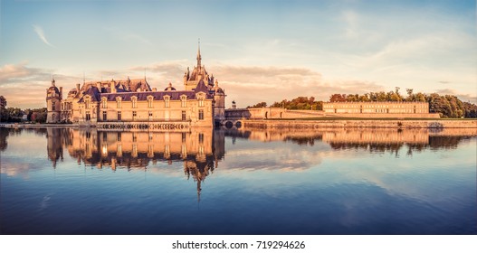 Chateau De Chantilly In The Warm Sunset Light.