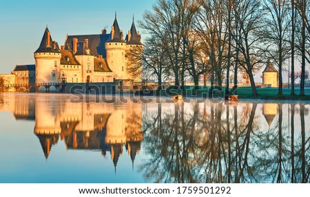 Chateau de Sully-sur-Loire in the sunset light, France. It is a famous landmark of the Loire Valley. Beautiful sunny view of the medieval castle with reflections in water. Old fortress in summer