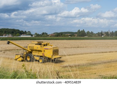 Chateauneuf-sur-Loire, France - August 2, 2012: Threshing machine on a field near a small village.