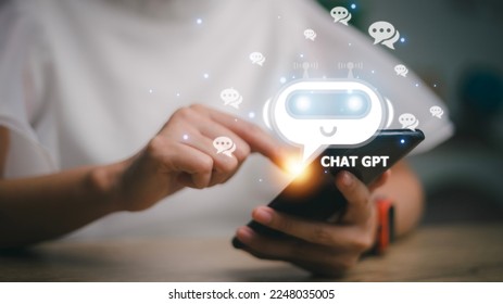 ChatGPT Chat with AI or Artificial Intelligence. woman chatting with a smart AI or artificial intelligence using an artificial intelligence chatbot developed by OpenAI. - Shutterstock ID 2248035005