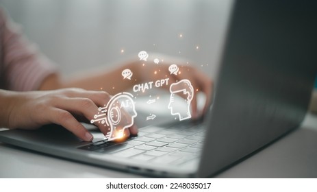ChatGPT Chat with AI or Artificial Intelligence. woman chatting with a smart AI or artificial intelligence using an artificial intelligence chatbot developed by OpenAI. - Shutterstock ID 2248035017