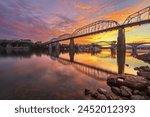 Chattanooga, Tennessee, USA on the Tennessee River with landmark bridges just after sunset.