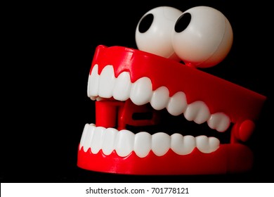 Chattering teeth toy taken from a three quarter frontal angle with short depth of field, looking left, open mouth