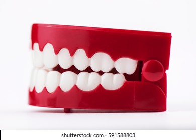 Chattering toy teeth close up from the side view isolated in a white studio background.