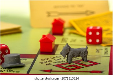 CHATTERIS, CAMBRIDGESHIRE, UK - NOVEMBER 26, 2017: A Closeup Shot, With A Narrow Depth Of Field, Of The Board Game Monopoly, Focussed On The Board And Dog Playing Piece.