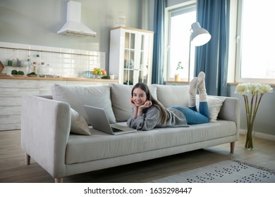 Chatting with friends. Young girl in a grey sweater chatting online - Shutterstock ID 1635298447