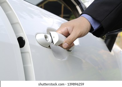 Chauffeur Or Driver Hand Opening White Car Door